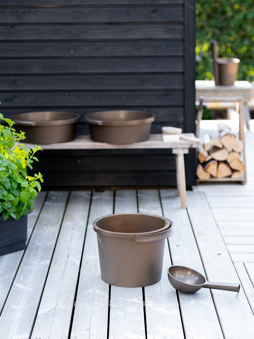 Orthex sauna bucket and scoop in front of sauna building