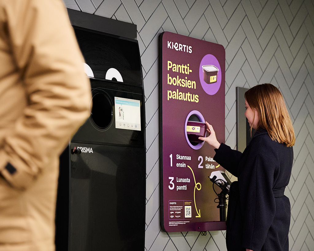 A woman returning a reusable food container